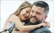  ?? Pam Panchak/Post-Gazette ?? Steven D'Achille and his daughter, Adriana, speak at the opening of the Alexis Joy D'Achille Center for Perinatal Mental Health at West Penn Hospital in December 2018.