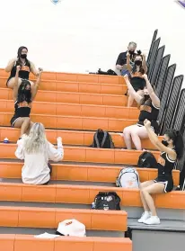  ?? MARTY O’BRIEN/STAFF ?? Tabb cheerleade­rs were among the few spectators Wednesday as the Tigers hosted New Kent in one of the first public high school sporting events in Hampton Roads since March 12.