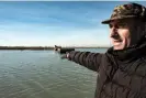  ?? Photograph: Marta Clinco/The Guardian ?? Natale Mantovan, a fisher from Pila on the Po delta, pointing out the sunken buildings of Batteria island.