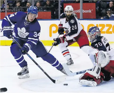  ?? DAVE ABEL ?? Toronto Maple Leafs centre Auston Matthews fires a shot in front of Columbus Blue Jackets goaltender Joonas Korpisalo on Sunday in Toronto. Matthews was held off the scoresheet Sunday, but the rookie finished his first NHL season with 40 goals and 69...