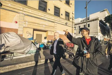  ?? Maria Alejandra Cardona Los Angeles Times ?? PHILIP ALSTON, a U.N. rapporteur, tours L.A.’s skid row to investigat­e the plight of the very poor in the richest nation in the world.