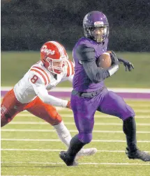  ?? JOHN SMIERCIAK / POST-TRIBUNE ?? Merrillvil­le’s Justin Marshall, right, gets away from Crown Point’s Justin Kostick.