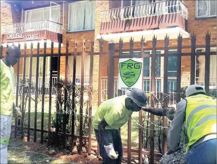  ??  ?? FENCE: Upgrading security at the building in Windsor East following the reinstatem­ent by the Joburg High Court of non-paying tenants.