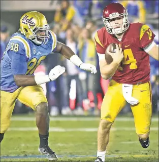  ?? Getty Images ?? SAM OLD STORY: USC quarterbac­k Sam Darnold (eluding UCLA’s Takkarist McKinley last year), may not declare for the NFL draft after the upcoming season, which would be bad news for any team — including the Jets — targeting him as its QB savior.