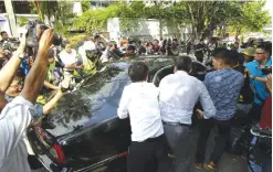  ??  ?? KUALA LUMPUR: Journalist­s surround a car of North Korean Ambassador to Malaysia Kang Chol leaving the embassy in Kuala Lumpur, Malaysia yesterday. — AP