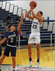  ?? AUSTIN HERTZOG - DIGITAL FIRST MEDIA ?? Pottstown’s Anthony Brown (23) shoots a jumper over Upper Merion’s Lucas Kim (2).