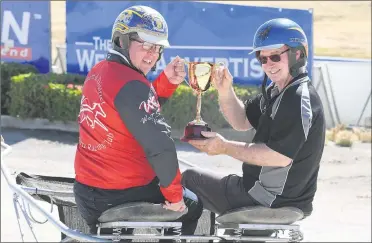  ?? ?? TOP PRIZE: The Weekly Advertiser general manager Brendan O’loughlin, left, and Horsham Harness Racing Club president Terry Lewis with the 2023 Horsham Pacing Cup. Picture: PAUL CARRACHER