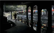  ?? ERIC GAY, FILE - THE ASSOCIATED PRESS ?? In this March 24 file photo, a runner moves along a mostly deserted River Walk in San Antonio, where most restaurant­s and business are closed.