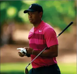  ?? ASSOCIATED PRESS ?? TIGER WOODS walks down the second fairway during the first round of the Wells Fargo Championsh­ip golf tournament at Quail Hollow Club in Charlotte, N.C., Thursday.