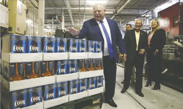  ?? Cole Burston/the Canadian Press files ?? Ontario Premier Doug Ford, left, has given scant details on how his government intends to give Ontarians more choice and convenienc­e in buying alcohol. Most provinces restrict beer sales to provincial­ly owned stores.