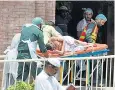  ??  ?? One of the estimated 200 people injured in the blast is rushed to hospital