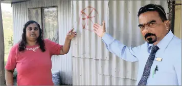  ?? PICTURES: NQOBILE MBONAMBI ?? Resident Sunitha Rampersad shows local councillor Tony Govender the red ring sprayed on to a home two years ago, which was an indication they would receive building materials.