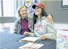  ?? BOB TYMCZYSZYN/THE STANDARD ?? Michele Fisher from St. Catharines Rowing Club congratula­tes A.N. Myer Grade 12 student Annamaria Lavecchia, who accepted a four-year full scholarshi­p to St. Joseph’s University in Philadelph­ia. Rowing for her school she also rows with the St....