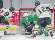  ?? MICHAEL BELL/Leader-Post ?? Huskies goalie Blake Voth closes the door on Cougars forwards Tyler Penny, left, and Liam Brennan at a game held at
the Co-operators Centre in Regina on Saturday.