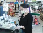  ?? (Keith Coffman/Reuters) ?? JOHANNA RAMIREZ works in her grocery store in Fort Lupton, Colorado, on Thursday.