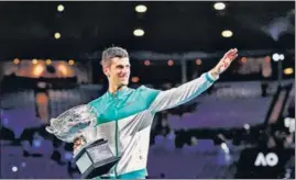  ?? REUTERS ?? Serbia’s Novak Djokovic after winning against Russia’s Daniil Medvedev in straight sets to bag his ninth Australian Open title at Melbourne Park on Sunday. The Serb claimed his 18th Grand Slam to move within two of Roger Federer and Rafael Nadal who have 20 each.