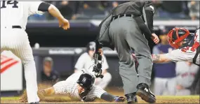  ?? Kathy Willens / Associated Press ?? Neil Walker watches as Gleyber Torres, center, evades the tag by Red Sox catcher Christian Vazquez, scoring on Brett Gardner’s two-run triple during the eighth inning on Wednesday.