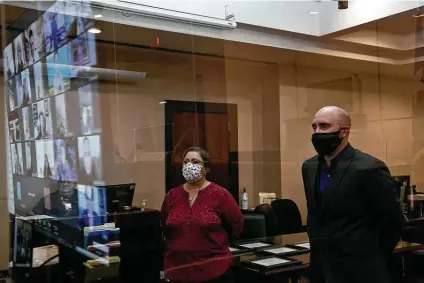  ?? Photos by Lisa Krantz / Staff photograph­er ?? Marine veteran Steven Bachleda and court support specialist Carolyn Alvarado watch judges, mentors, fellow graduates and others involved with the program on Zoom during Bachleda’s graduation from Felony Veterans Treatment Court.