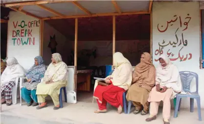  ?? — AFP ?? RAWALAKOT, Pakistan: In this photograph taken on November 21, 2016, Pakistani Kashmiri women wait outside the office of social worker Nusrat Yousuf to discuss their social issues with her in the women’s market on the outskirts of the town of Rawalakot,...