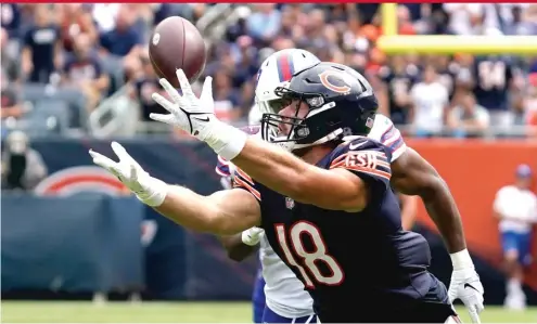  ?? NAM Y. HUH/AP ?? Tight end Jesse James catches a pass from Justin Fields on Saturday at Soldier Field. Fields led the Bears on two scoring drives against the Bills.