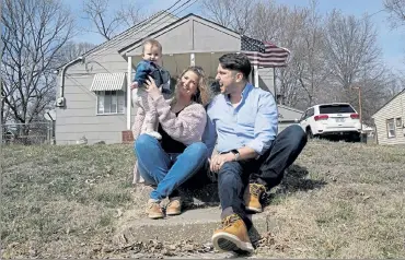  ?? CHARLIE RIEDEL / AP ?? Logan DeWitt with his wife Mckenzie and daughter Elizabeth sit on the steps leading to their home Monday in Kansas
City, Kan. Because he could work at home, Logan kept his job through the pandemic while his wife lost hers and went back to school. Their financial situation was further complicate­d with the birth of their daughter nine months ago.