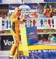  ?? MATT SLOCUM/ASSOCIATED PRESS ?? Kyle Busch celebrates with teammates after winning the NASCAR race in Long Pond, Pennsylvan­ia on Sunday. It was his 59th career Cup victory.