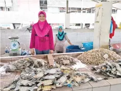  ??  ?? Tahirah at her fish stall at Kota Kinabalu Central Market.