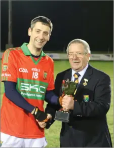  ??  ?? Rathnew captain Paul Merrigan accepts the 1916 Commemorat­ion Cup from County Chairman Martin Coleman.