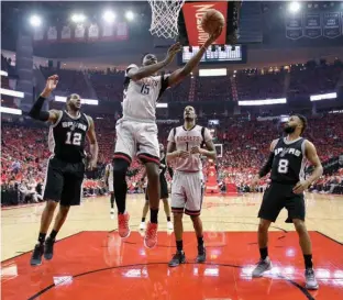  ?? Associated Press ?? Houston Rockets center Clint Capela (15) shoots as San Antonio Spurs forward LaMarcus Aldridge (12) and guard Patty Mills (8) watch during the first half in Game 6 on Thursday in Houston.