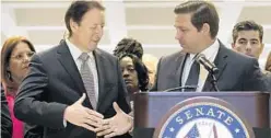  ?? AP 2019 ?? Gov. Ron DeSantis shakes Florida Senate President Bill Galvano’s hand at the end of session. Businesses are pushing leaders to make temporary tax cuts permanent.