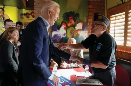  ?? Kevin Lamarque/Reuters ?? Joe Biden greets a supporter during a campaign event at a Mexican restaurant in the Phoenix area of Arizona, on Tuesday. Photograph: