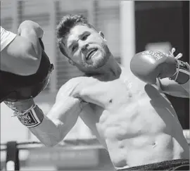  ?? Photograph­s by Damian Dovarganes Associated Press ?? CANELO ALVAREZ says he is “motivated to give the fans a beautiful fight and answer a lot of questions” in his quest to defeat unbeaten Gennady Golovkin.