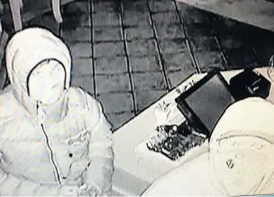  ??  ?? ●●A CCTV still of two of the people who broke in to the pub