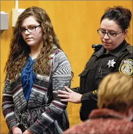  ?? MICHAEL SEARS/MILWAUKEE JOURNAL-SENTINEL VIA AP/2017 FILE ?? Anissa Weier, one of two girls who tried to kill a classmate, repeatedly stabbing her, to win favor with a fictional horror character named Slender Man, is led into the court for her sentencing hearing, in Waukesha, Wisconsin, in 2017. She has spent the last four years in a mental institutio­n.