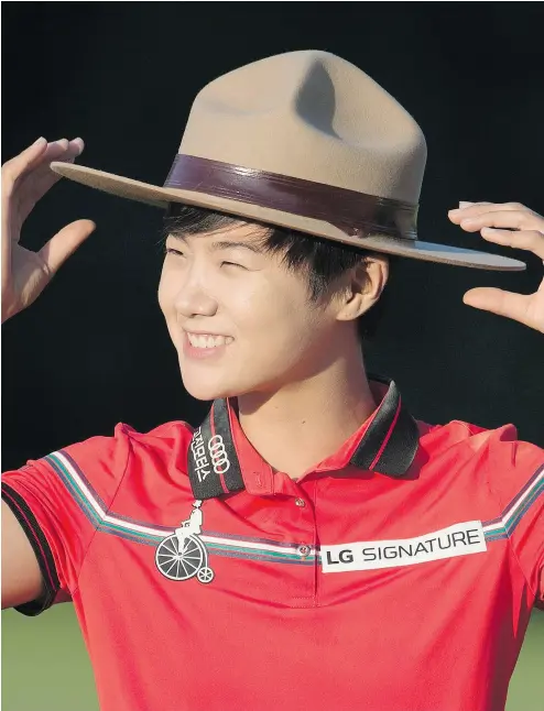  ?? ADRIAN WYLD / THE CANADIAN PRESS ?? Sung Hyun Park of South Korea tries on a Mountie hat after winning the 2017 Canadian Pacific Women’s Open in Ottawa on Sunday. Brooke Henderson, the top Canadian, tied for 12th.