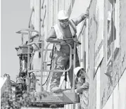  ?? Mark Humphrey / Associated Press ?? Workers build an apartment and retail complex in Nashville this fall. The Labor Department said Wednesday that worker productivi­ty has increased.