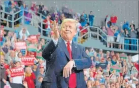  ?? AFP ?? President Trump delivers remarks as fake snow falls at a Make America Great Again rally.