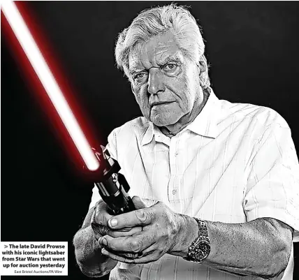  ?? East Bristol Auctions/PA Wire ?? The late David Prowse with his iconic lightsaber from Star Wars that went up for auction yesterday