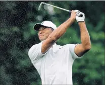  ?? ASSOCIATED PRESS PHOTO/CHARLIE RIEDEL ?? Tiger Woods hits from the first fairway during a practice round for the PGA Championsh­ip golf tournament Tuesday at Bellerive Country Club in St. Louis.