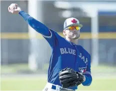  ?? FRANK GUNN/ THE CANADIAN PRESS ?? Josh Donaldson tosses a ball at spring training in Dunedin, Fla., Monday. The third baseman has told Blue Jays’ general manager Ross Atkins that he wants to focus on the upcoming season, not his contract situation.