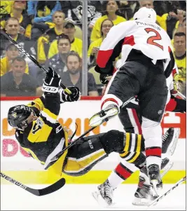 ?? BRUCE BENNETT / GETTY IMAGES ?? The Senators’ Dion Phaneuf checks the Penguins’ Bryan Rust to the ice in the first period. Rust did not return to the game after the hit.