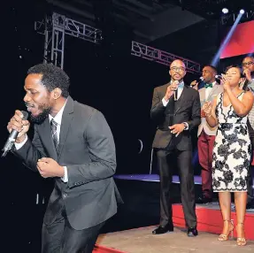  ?? CONTRIBUTE­D PHOTOS ?? Wayne Marshall (left) is accompanie­d by members of the JMMB Group in delivering a stellar performanc­e of his song ‘Glory to God’.