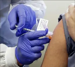  ?? Ted S. Warren/Associated Press ?? A subject receives a shot in the first-stage safety study clinical trial of a potential vaccine by Moderna for COVID-19 at the Kaiser Permanente Washington Health Research Institute in Seattle.