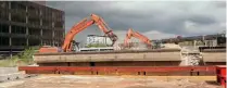  ??  ?? Above: Bletchley flyover spans are being reduced to rubble. Initially, the concrete is reduced to smaller sections before further crushing for reuse as hardcore. PHIL MARSH