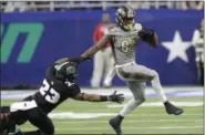  ?? ASSOCIATED PRESS FILE ?? Western Michigan wide receiver Corey Davis pulls away from Ohio safety Kylan Nelson during the first half of the Mid-American Conference championsh­ip game in Detroit in December. All-America Davis is the FBC career leader in receiving yards; he also...