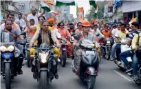  ?? PTI ?? Union textiles minister Smriti Irani rides a scooter as she participat­es in a Tiranga Yatra in Surat on Thursday. —