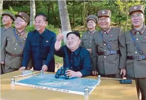  ?? EPA PIC ?? North Korea leader Kim Jong-un supervisin­g the test-fire of the ground-to-ground medium-to-long range strategic ballistic missile Pukguksong-2 in North Korea.