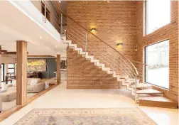  ??  ?? WOW FACTOR: The modern staircase leading to the first floor, which has sweeping views of the surroundin­g areas.