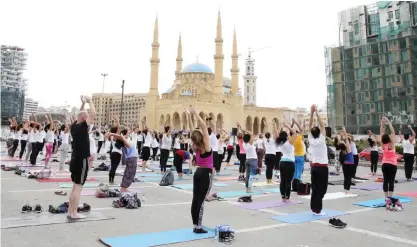  ??  ?? BEIRUT: Young people practice yoga in Beirut’s Martyrs Square in the heart of the Lebanese capital yesterday. The special 108 Sun Salutation­s event was aimed to help restore prana (positive energy) and raise consciousn­ess towards harmony, organizers...