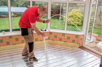  ??  ?? Below: A slimprofil­e over-floor UFH system from Wunda being installed into pregrooved insulating panels as part of works to update an existing conservato­ry